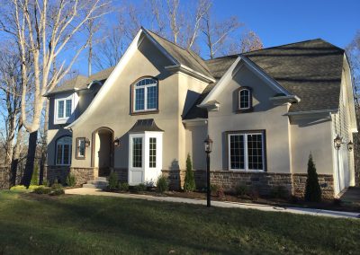Front exterior shot of the home painted tan-white.