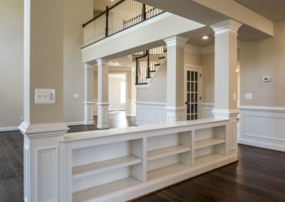 Open dining room and living room area with white and brown accents.